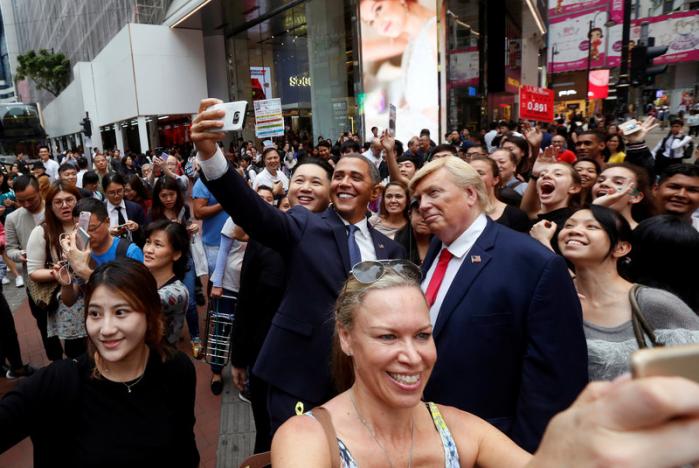 Impersonators of North Korean leader Kim Jong-un, former U.S. President Barack Obama, and U.S. President Donald Trump pose in Hong Kong