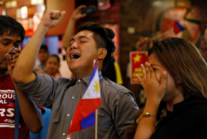 Activists who travelled to disputed Scarborough Shoal and were blocked by Chinese Coastguard a few months ago, jubilate after a ruling on the disputed South China Sea by an arbitration court in Hague in favor of Philippines, at a restaurant in Manila