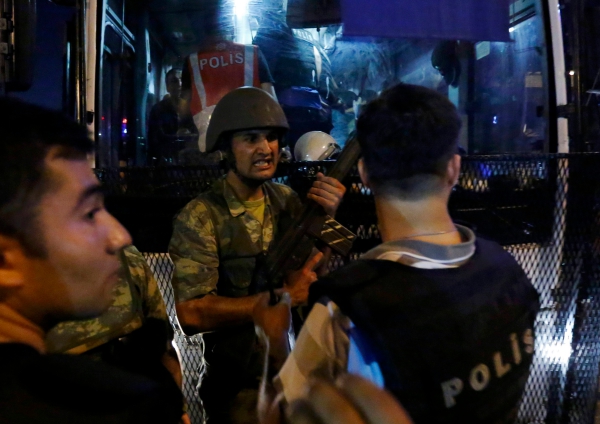 Turkish soldiers surrender their weapons to policemen during an attempted coup in Istanbul's Taksim Square