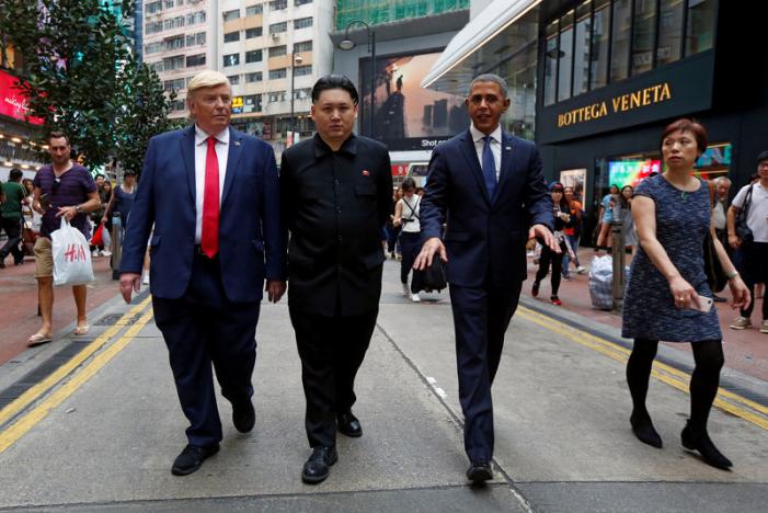 Impersonators of North Korean leader Kim Jong-un, former U.S. President Barack Obama, and U.S. President Donald Trump walk in Hong Kong