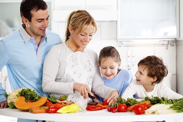 Happy family preparing a healthy dinner at home.