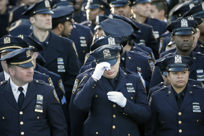 Policemen line-up near the Christ Tabernacle Church ahead of the funeral services of NYPD officer Ramos in the Queens borough of New York