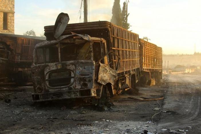 Damaged aid trucks are pictured after an airstrike on the rebel held Urm al-Kubra town