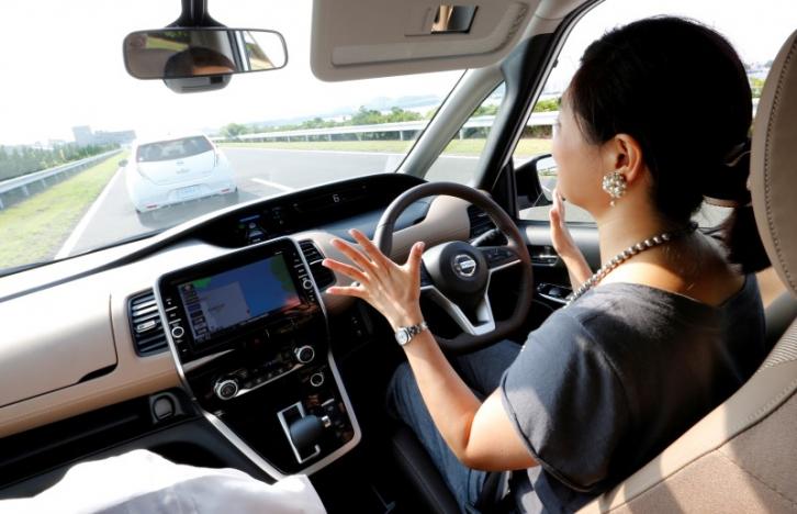 Reuters auto correspondent Shiraki removes her hands from the steering wheel as she test drives Nissan's new Serena minivan, which is equipped with Propilot semi-automated driving functions, at the company's test drive facility in Yokosuka