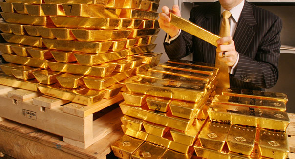 Robert R. McEwen, chairman of Goldcorp Inc., holds a gold ba