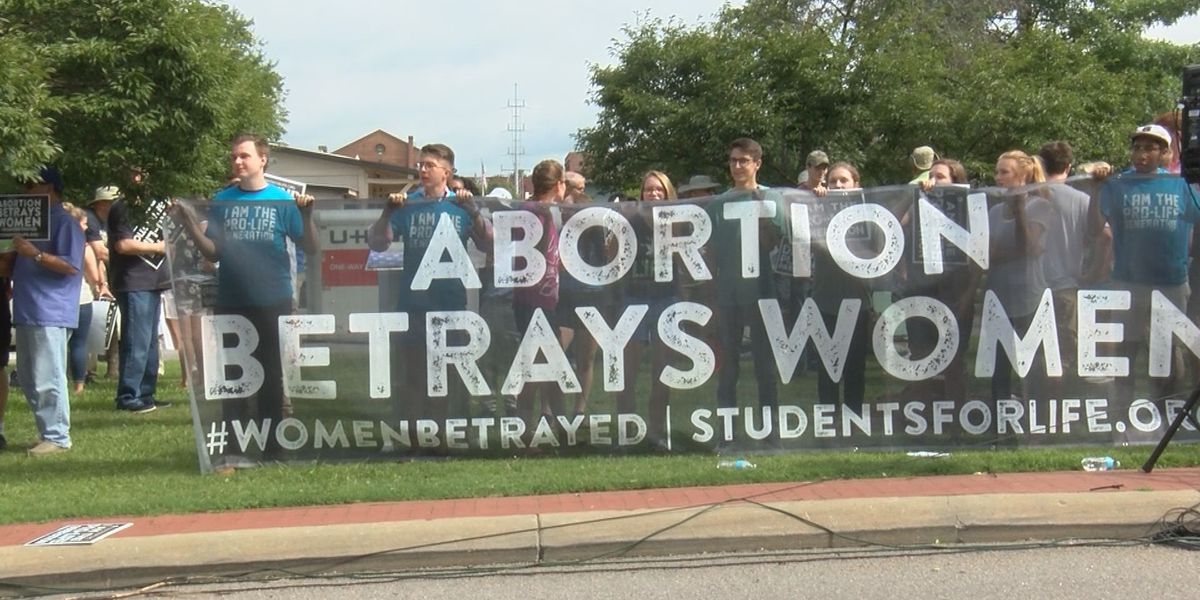 Người biểu tình giơ biểu ngữ: "Phá thai lừa dối phụ nữ" bên ngoài diễn đàn của Đảng Dân chủ. 