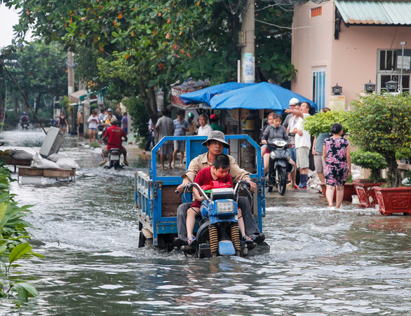 Đường Phạm Hùng, huyện Bình Chánh ngập nặng, gây khó khăn cho người dân qua lại. (Ảnh qua tuoitre)