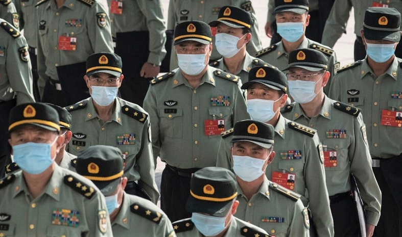 Các đại biểu từ Lực lượng vũ trang Trung Quốc đeo mặt nạ bảo hộ khi đến khai mạc Đại hội Đại biểu Nhân dân Toàn quốc tại Đại lễ đường Nhân dân ở Bắc Kinh, Trung Quốc, vào ngày 22 tháng 5 năm 2020 (Kevin Frayer / Getty Images)